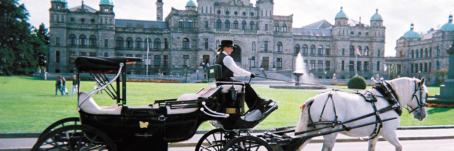 Horse drawn carriage in front of the Parliament Buildings in Victoria, BC 